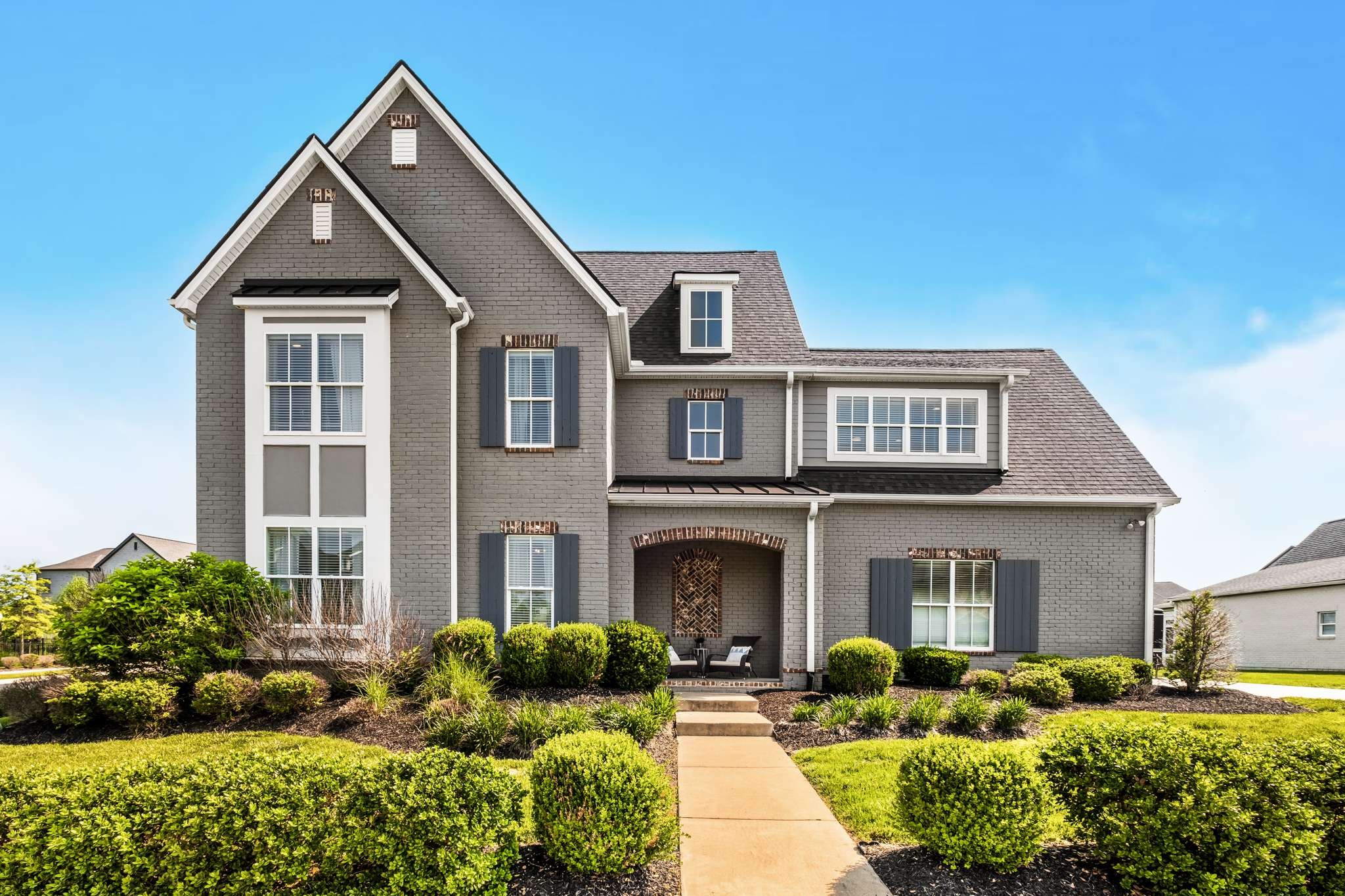 a front view of a house with garden and porch