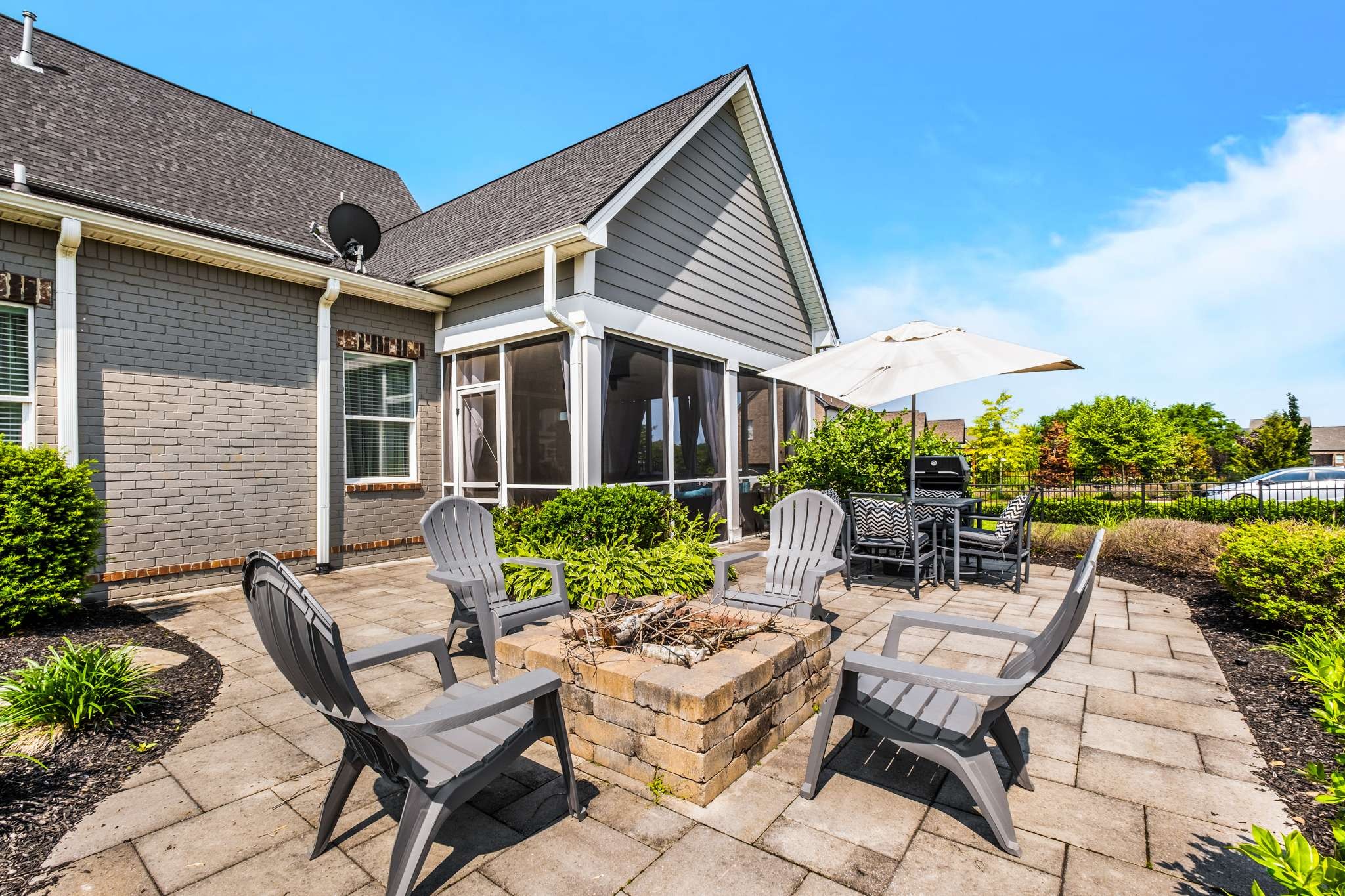 107 Vanner Road Mount Juliet, TN 37122 - Photo 40 of 54 a view of a patio with couches table and chairs under an umbrella