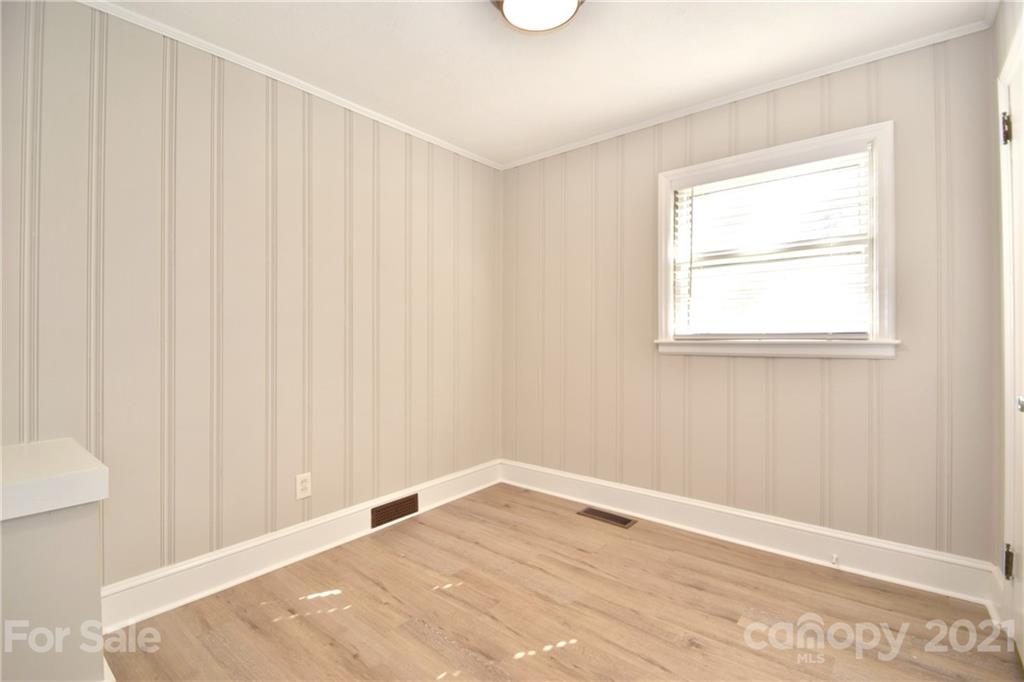 1727 Merry Oaks Road Charlotte, NC 28205 - Photo 12 of 20 a view of an empty room with wooden floor and a window