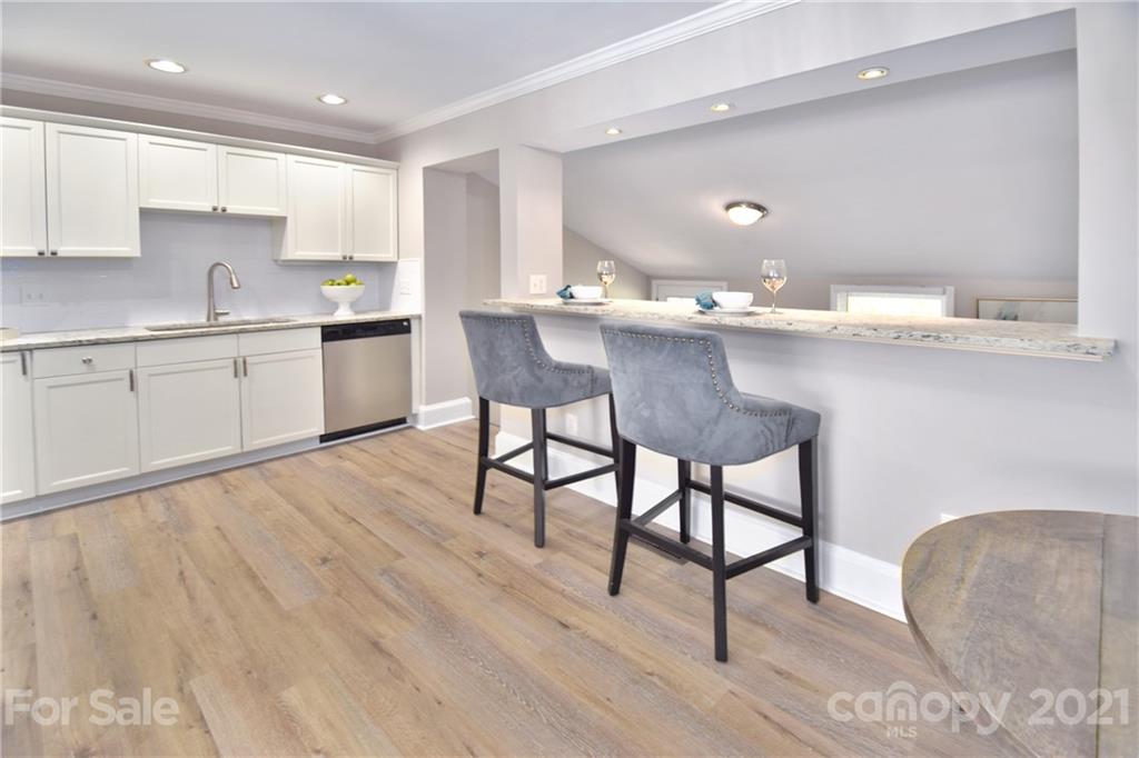 1727 Merry Oaks Road Charlotte, NC 28205 - Photo 5 of 20 a kitchen with granite countertop a sink cabinets and wooden floor