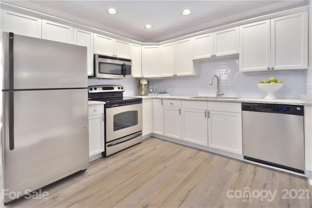 1727 Merry Oaks Road Charlotte, NC 28205 - Photo 6 of 20 a kitchen with stainless steel appliances a refrigerator sink and microwave