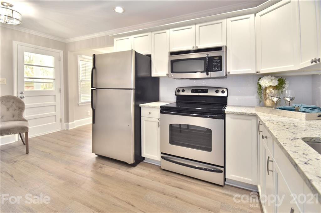 1727 Merry Oaks Road Charlotte, NC 28205 - Photo 7 of 20 a kitchen with a refrigerator stove and microwave