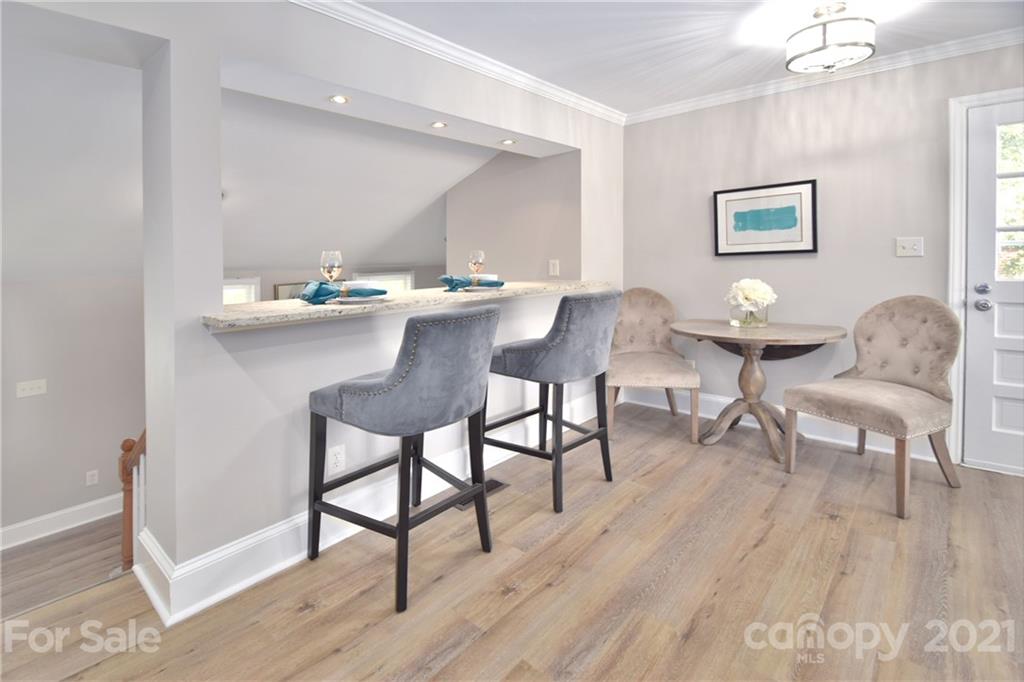1727 Merry Oaks Road Charlotte, NC 28205 - Photo 9 of 20 a view of a dining room with furniture and wooden floor