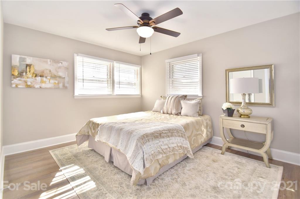 1727 Merry Oaks Road Charlotte, NC 28205 - Photo 10 of 20 a bedroom with a bed and a chandelier