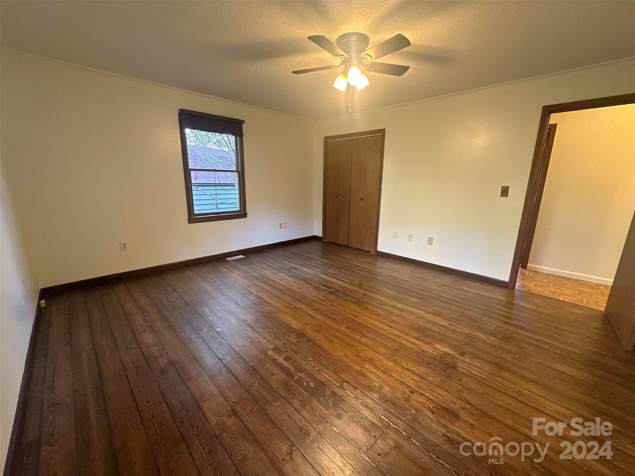 52 Sugar Loaf Road Sylva, NC 28779 - Photo 15 of 45 a view of an empty room with wooden floor and a chandelier fan