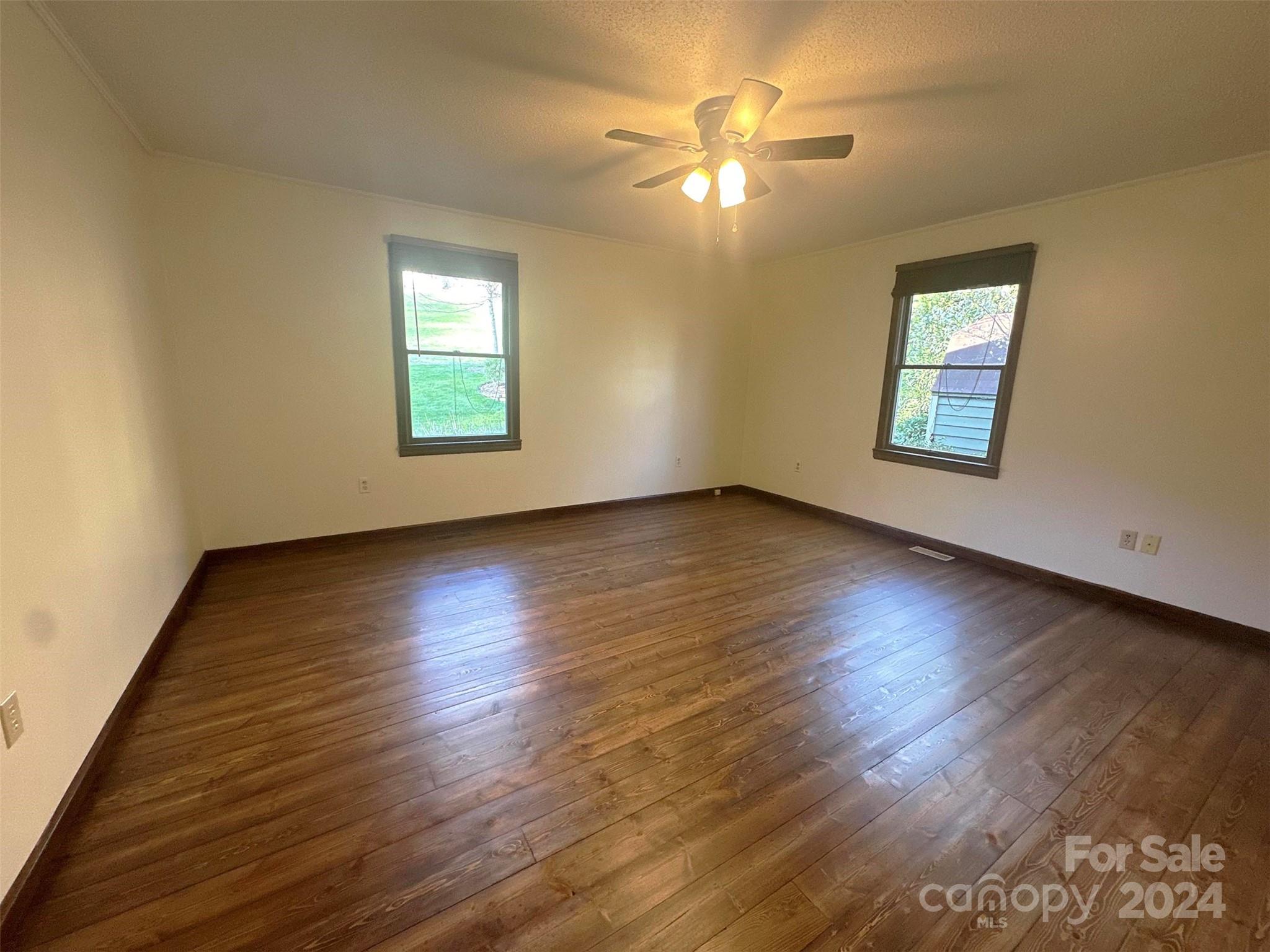 52 Sugar Loaf Road Sylva, NC 28779 - Photo 16 of 45 a view of an empty room with wooden floor and a window