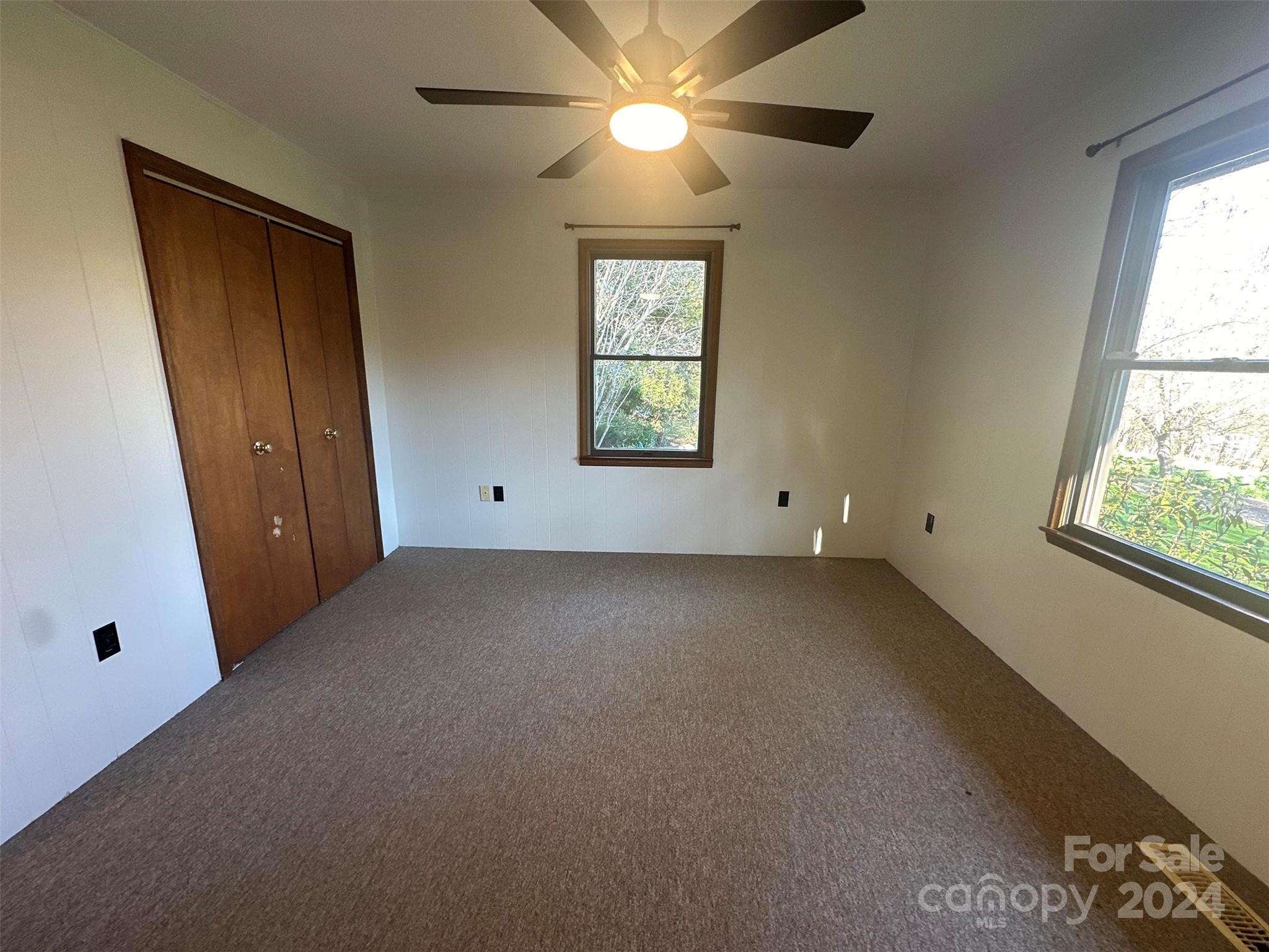 52 Sugar Loaf Road Sylva, NC 28779 - Photo 17 of 45 an empty room with windows and fan