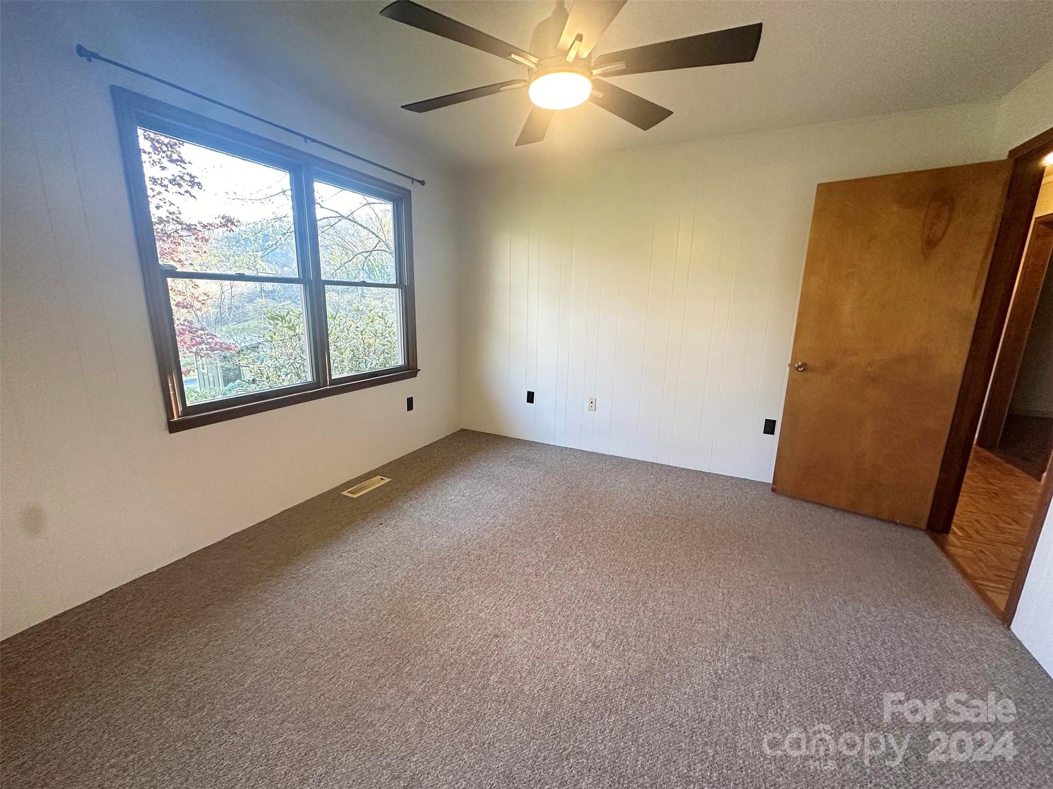52 Sugar Loaf Road Sylva, NC 28779 - Photo 18 of 45 an empty room with windows and fan