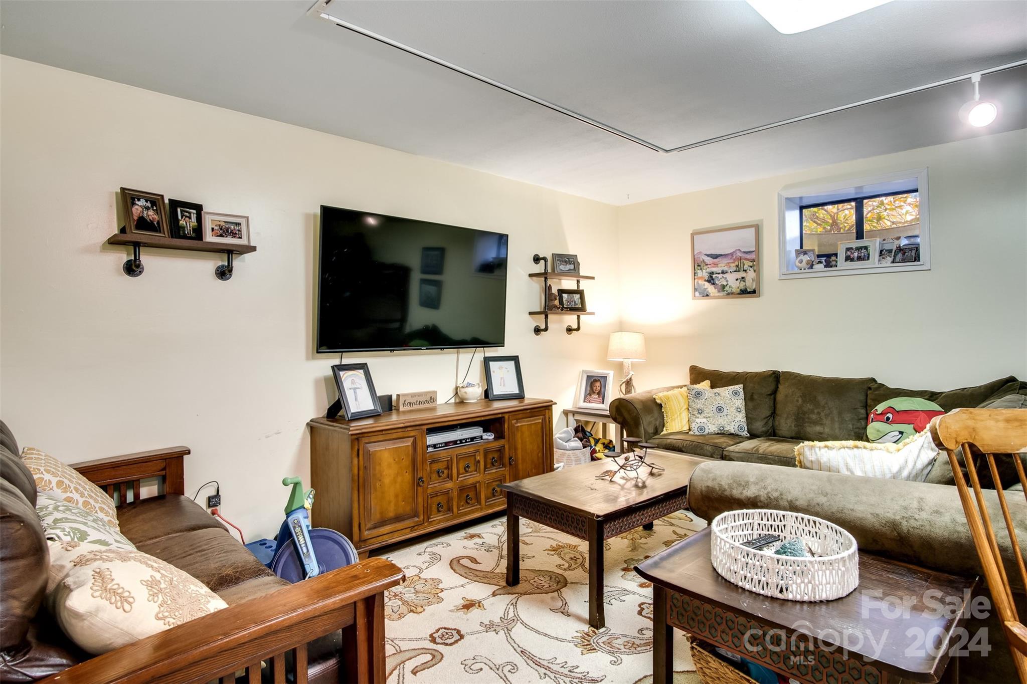 52 Sugar Loaf Road Sylva, NC 28779 - Photo 26 of 45 a living room with furniture and a flat screen tv