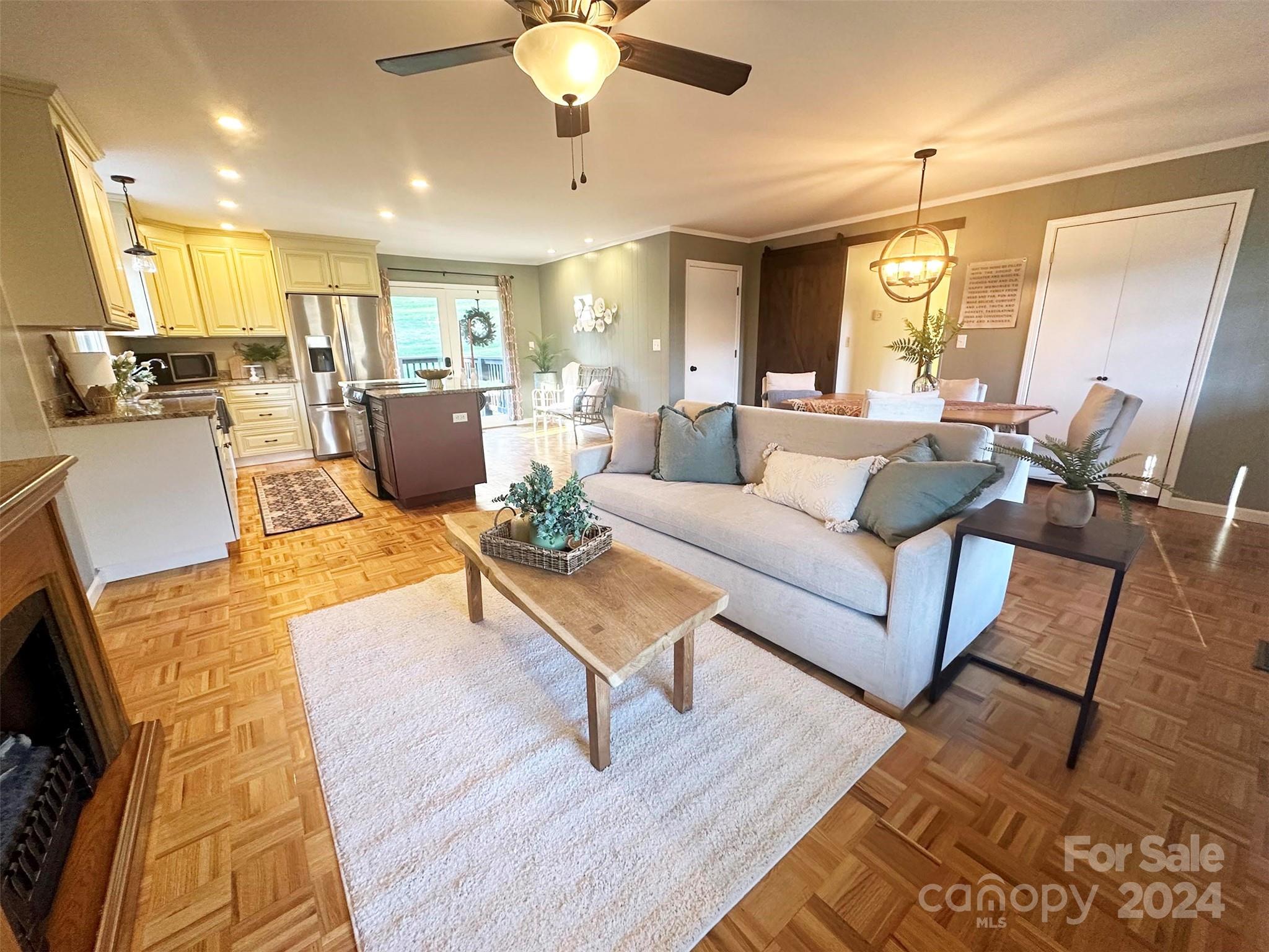 52 Sugar Loaf Road Sylva, NC 28779 - Photo 3 of 45 a living room with furniture kitchen view and a chandelier