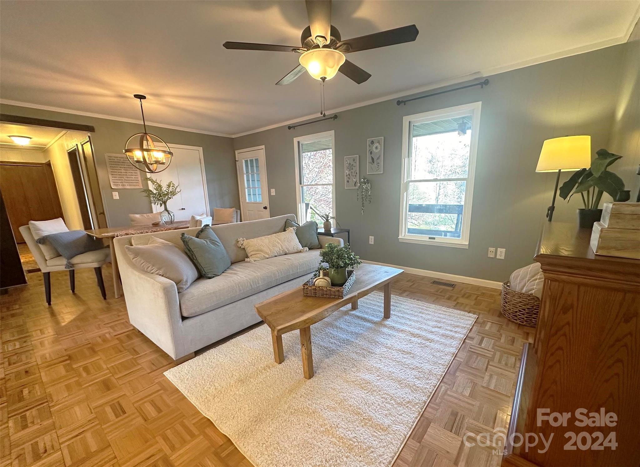 52 Sugar Loaf Road Sylva, NC 28779 - Photo 4 of 45 a living room with furniture and a chandelier