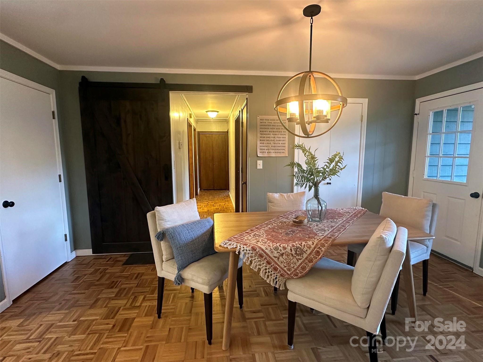 52 Sugar Loaf Road Sylva, NC 28779 - Photo 6 of 45 a dining room with furniture a chandelier and wooden floor