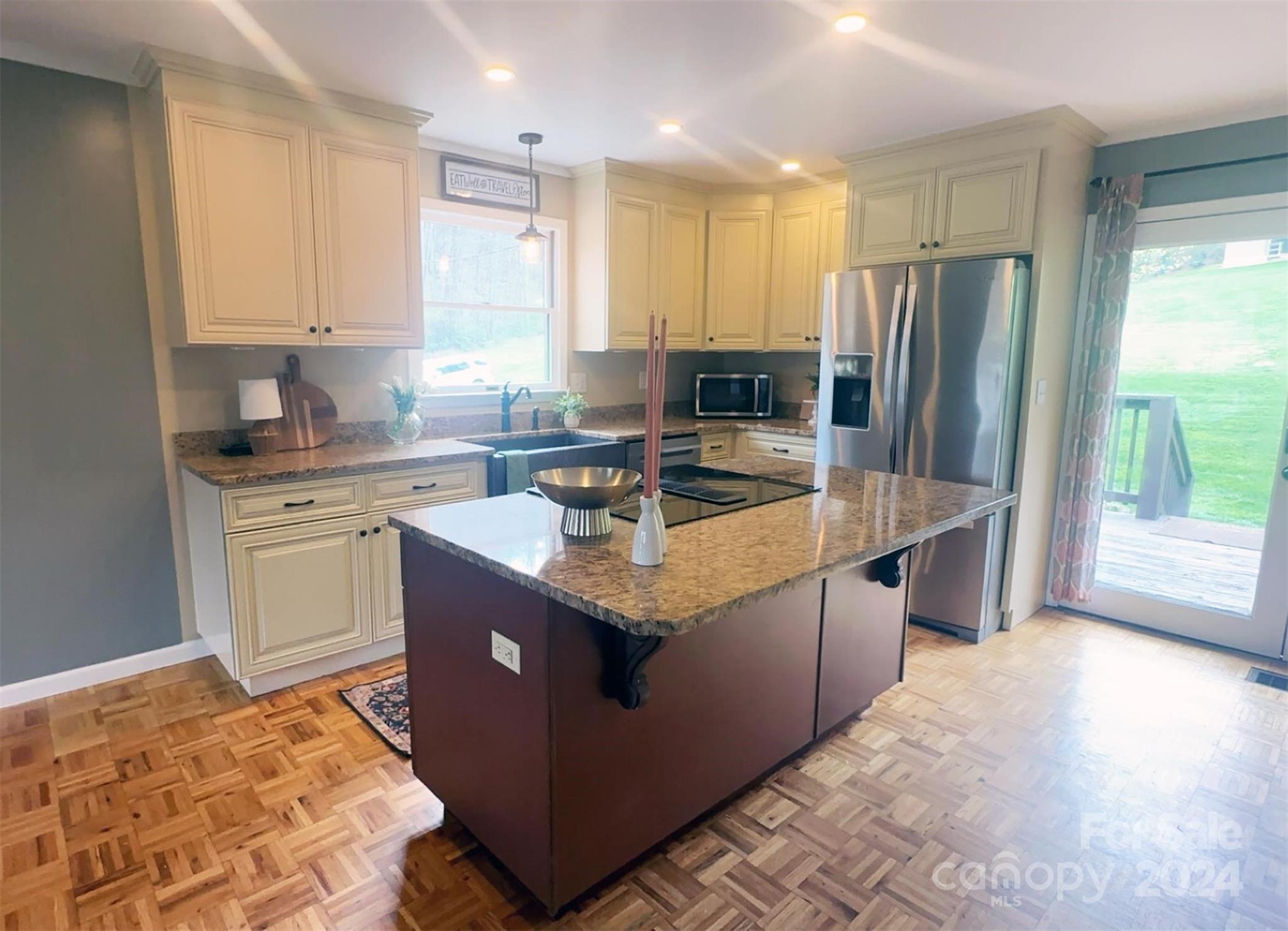 52 Sugar Loaf Road Sylva, NC 28779 - Photo 7 of 45 a kitchen with stainless steel appliances granite countertop a sink stove and refrigerator