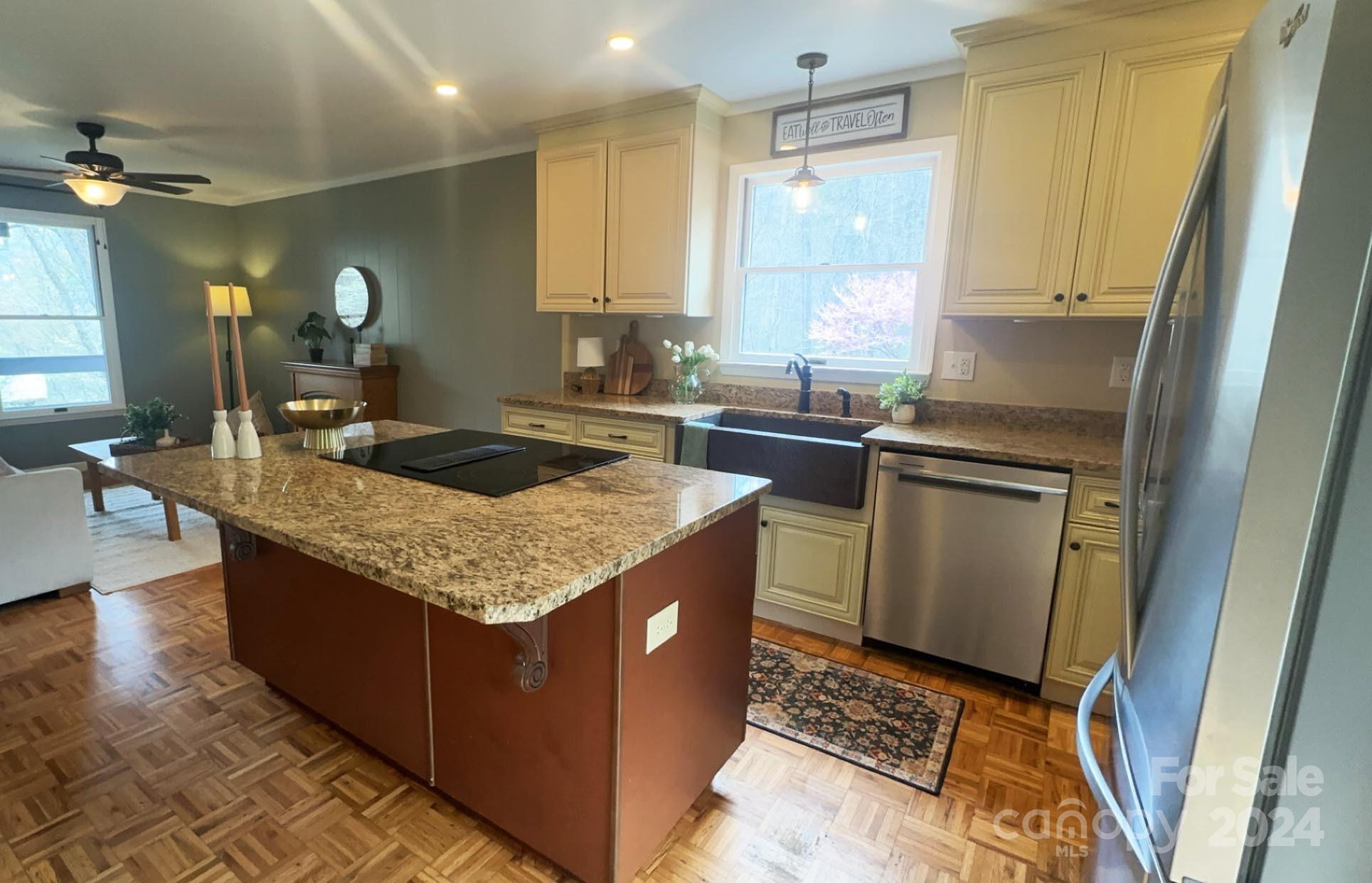 52 Sugar Loaf Road Sylva, NC 28779 - Photo 8 of 45 a kitchen with granite countertop a sink a counter top space and cabinets