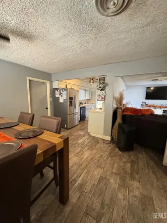 a kitchen with stainless steel appliances a refrigerator a sink a stove and wooden floor