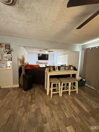 a kitchen with stainless steel appliances a refrigerator a sink a stove top oven a washer dryer and white cabinets