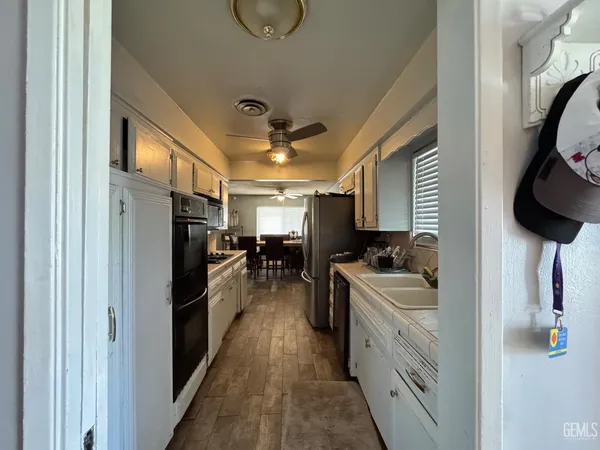 a living room with furniture a window and a lamp