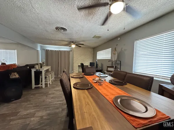 a view of a a dining room with furniture window and wooden floor