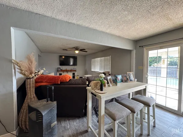 a living room with furniture a flat screen tv and a large window