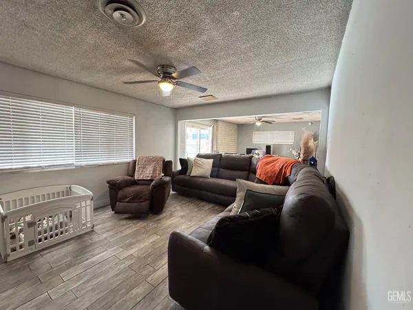a bedroom with bed and a chandelier