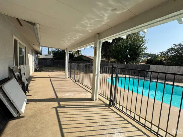 a view of a swimming pool with a yard