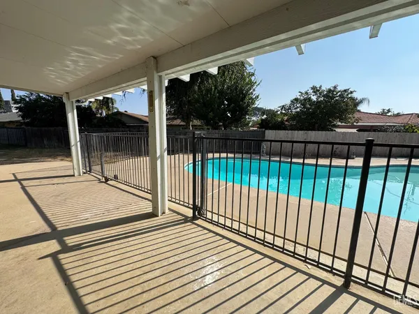 a view of a patio with table and chairs