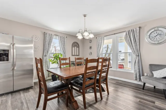 a dining room with furniture a window and wooden floor