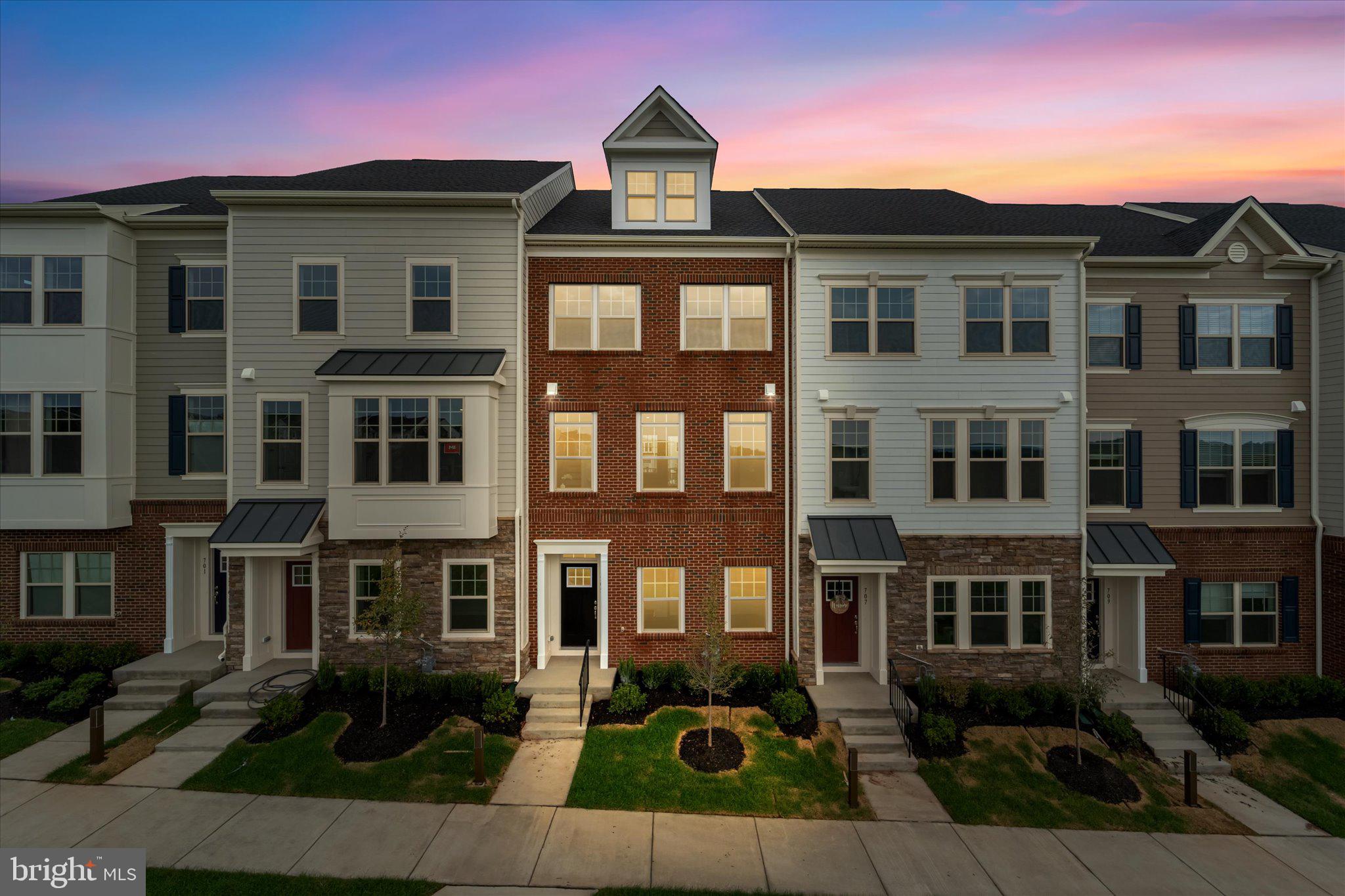a front view of a residential apartment building with a yard