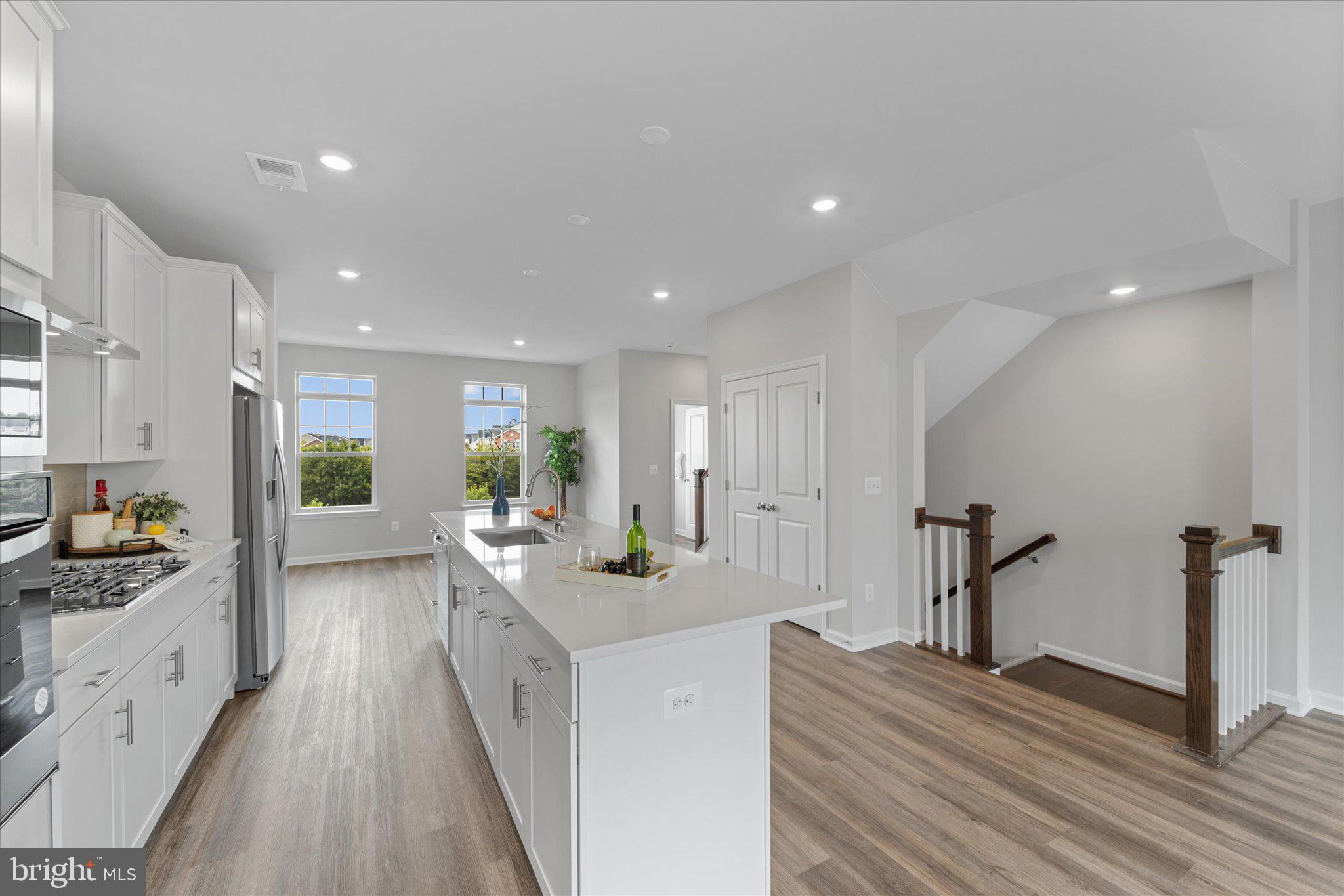 705 Sawback Square Northeast Leesburg, VA 20176 - Photo 13 of 38 a large white kitchen with sink and refrigerator