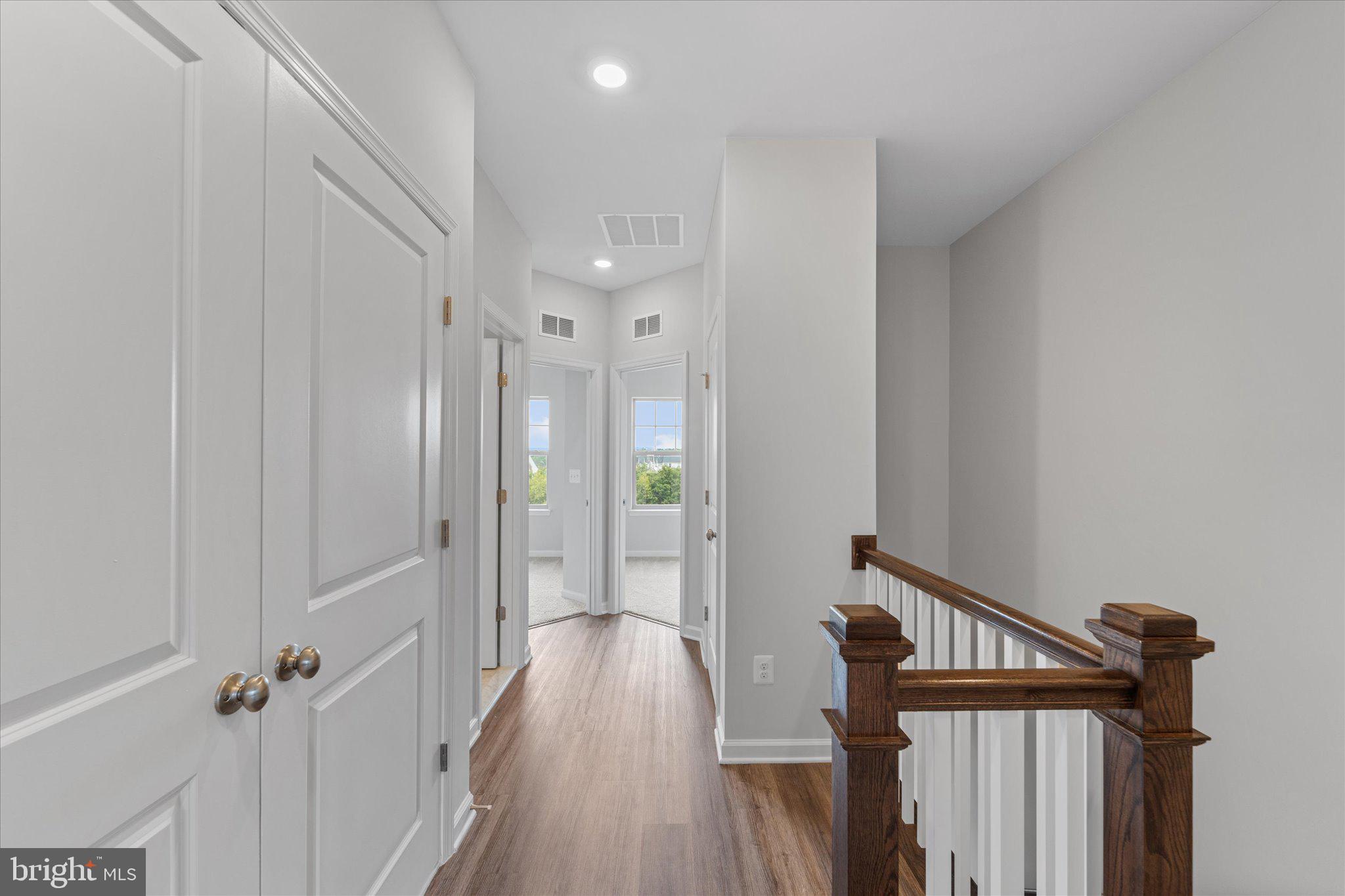 705 Sawback Square Northeast Leesburg, VA 20176 - Photo 18 of 38 a view of a hallway with wooden floor and staircase