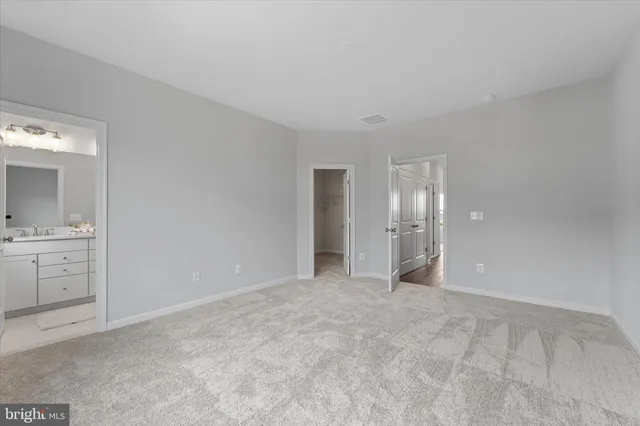 a view of an empty room with window and cabinet
