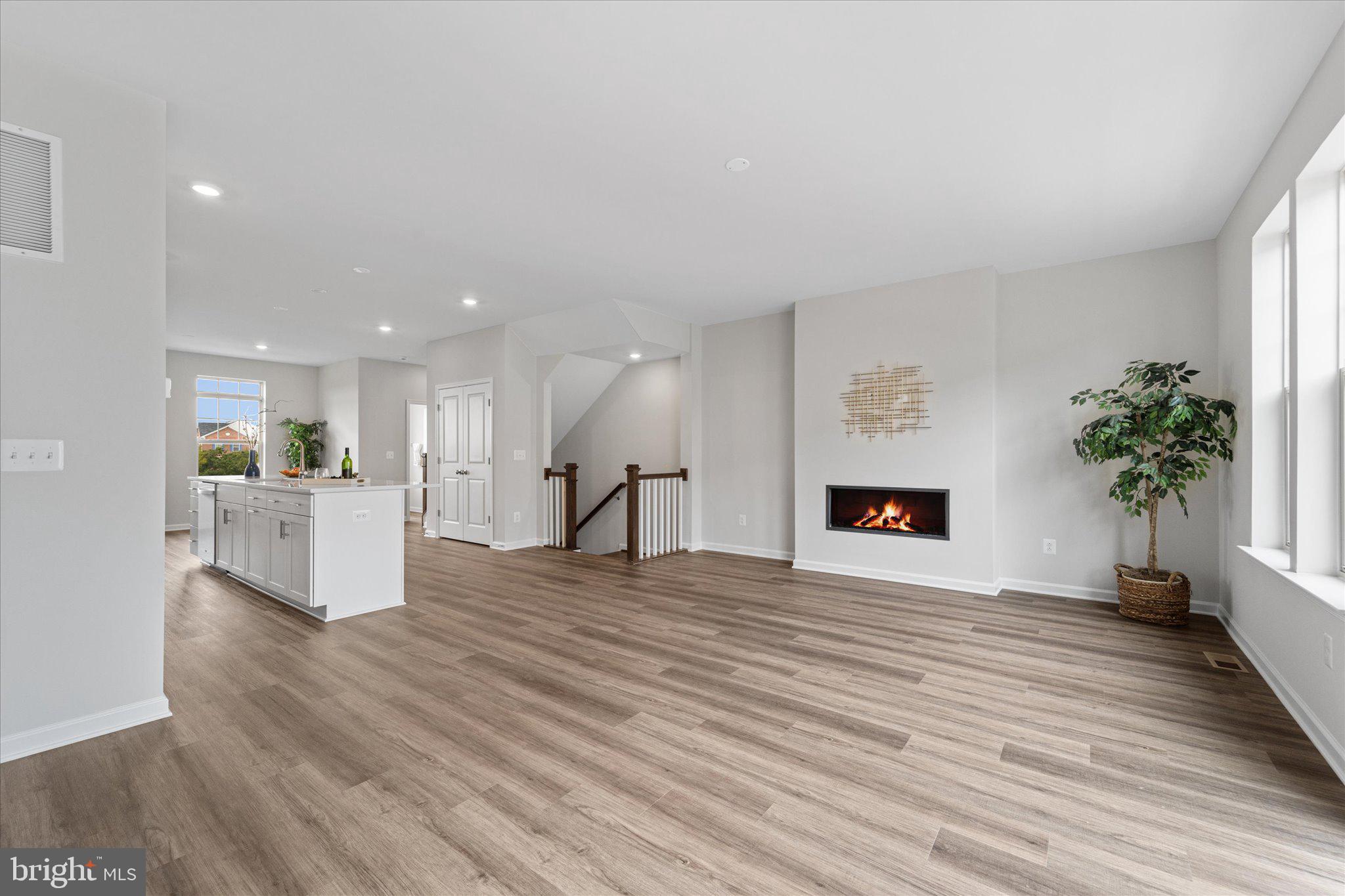 705 Sawback Square Northeast Leesburg, VA 20176 - Photo 2 of 38 a view of an empty room with wooden floor and a window