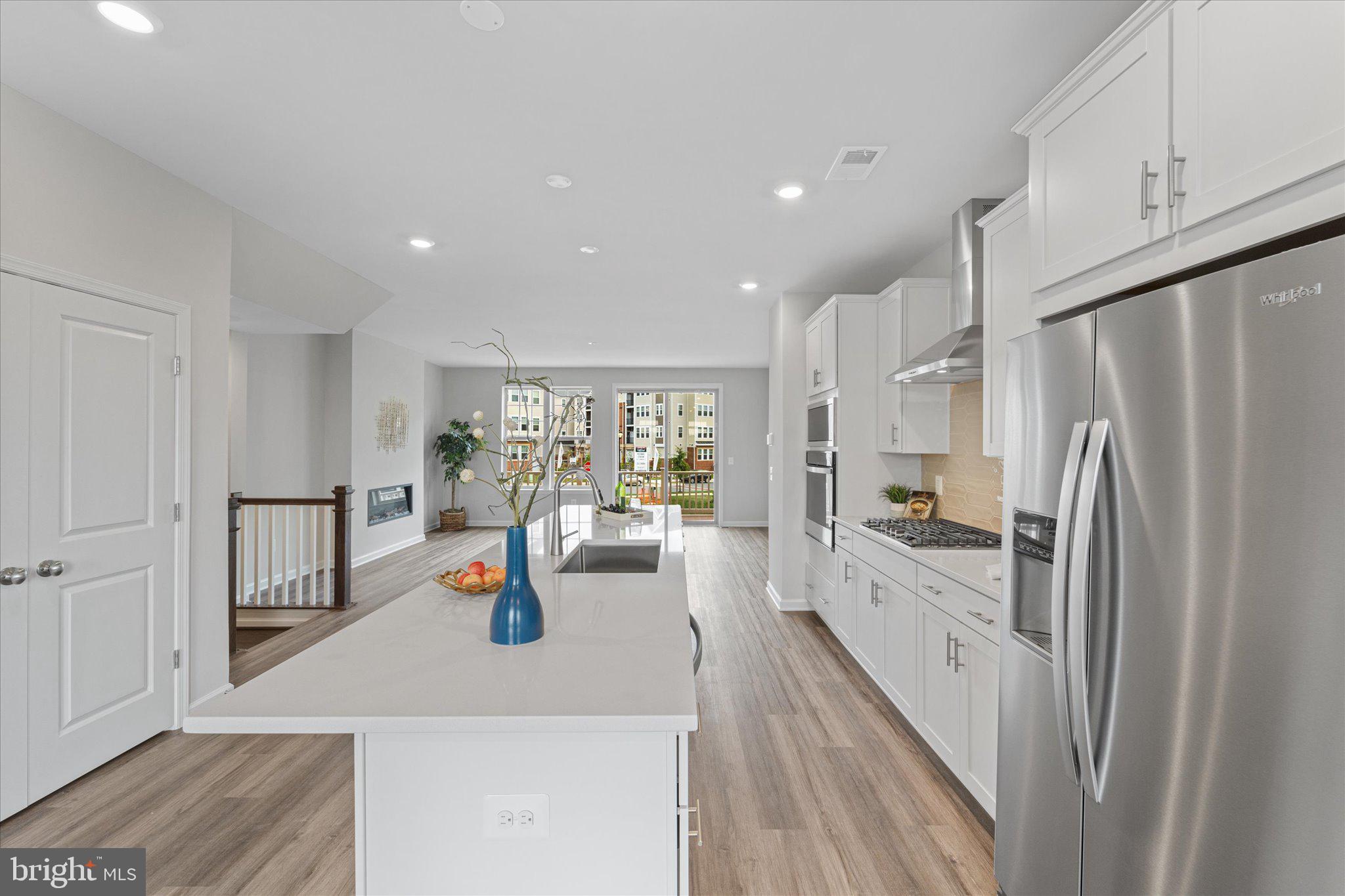 705 Sawback Square Northeast Leesburg, VA 20176 - Photo 8 of 38 a kitchen with stainless steel appliances a refrigerator sink and cabinets