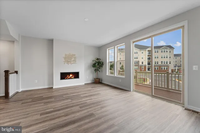 an empty room with wooden floor and fireplace