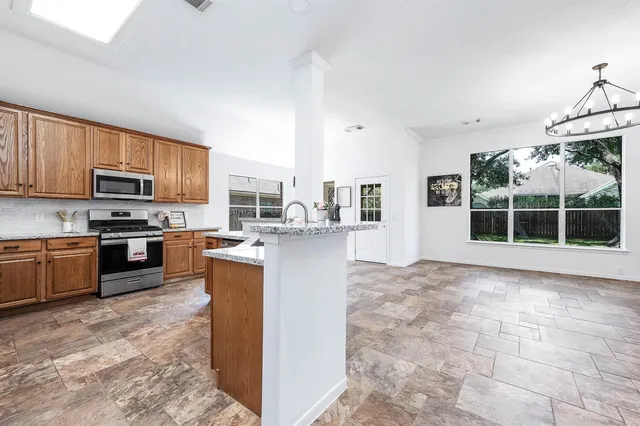 a large kitchen with cabinets and stainless steel appliances