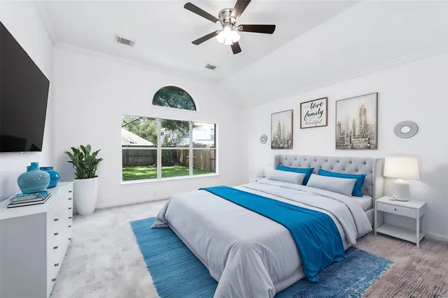 a bedroom with a large bed and a large window