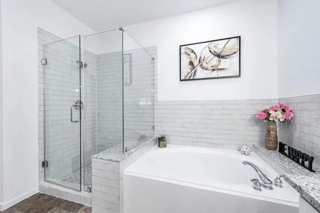 a bathroom with a tub and shower