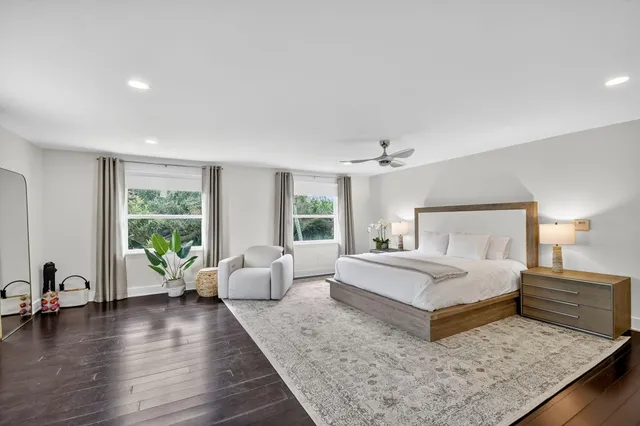 a spacious bedroom with a large bed and a couch