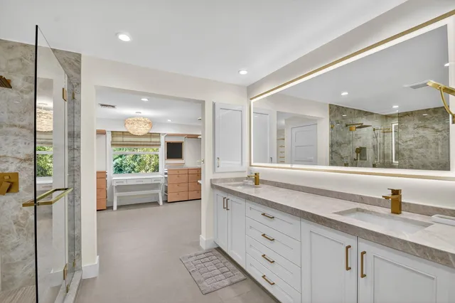 a large spacious bathroom with a granite countertop sink mirror and bathtub