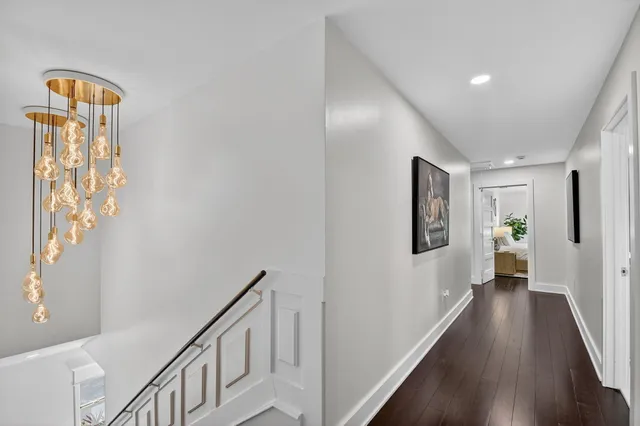 a view of hallway with wooden floor