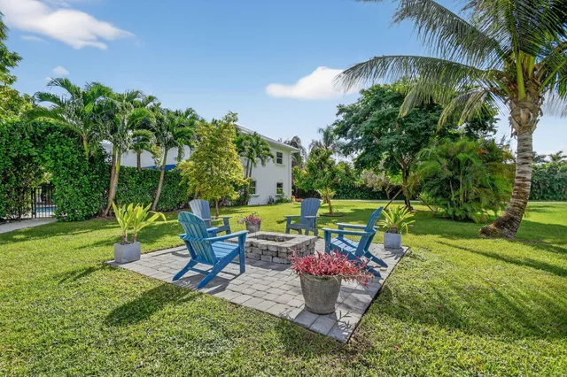a view of a swimming pool with a sitting area and a garden