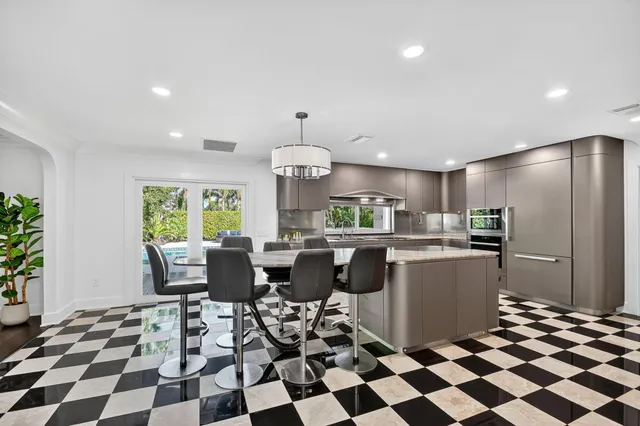 a kitchen with a checkered dining table and appliances