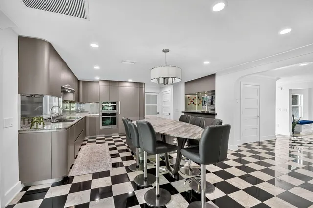 a kitchen with a checkered floor and white cabinets