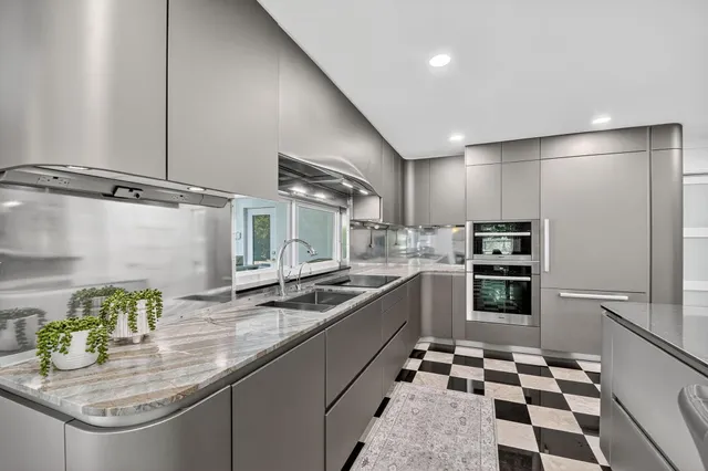a kitchen with granite countertop stainless steel appliances a sink and counter space