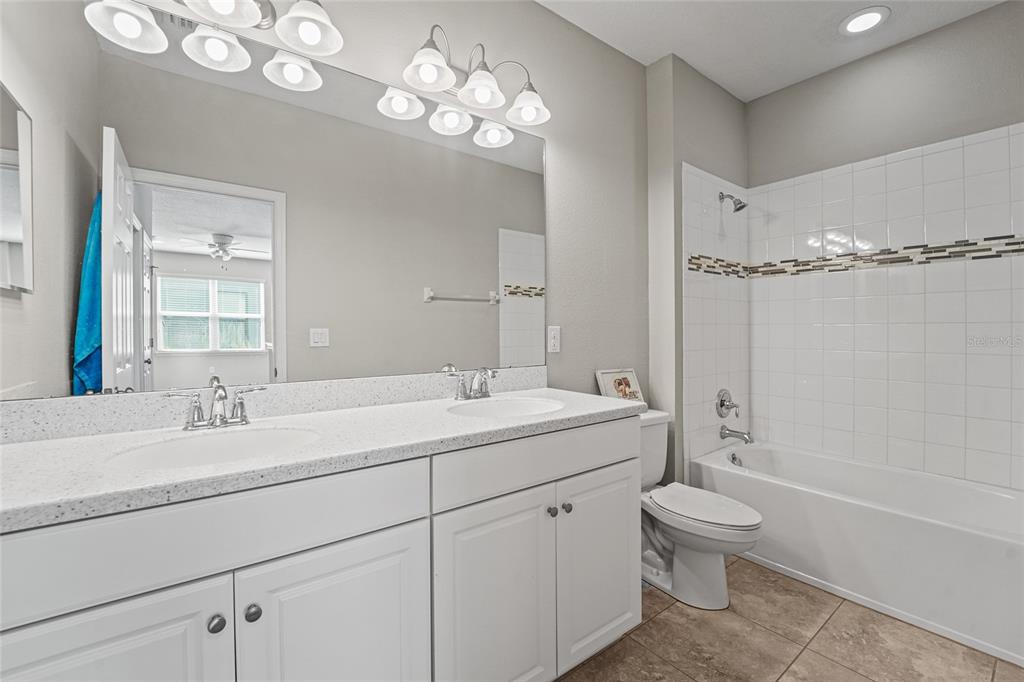 8903 Arabella Lane Seminole, FL 33777 - Photo 35 of 47 a bathroom with a sink a toilet and shower