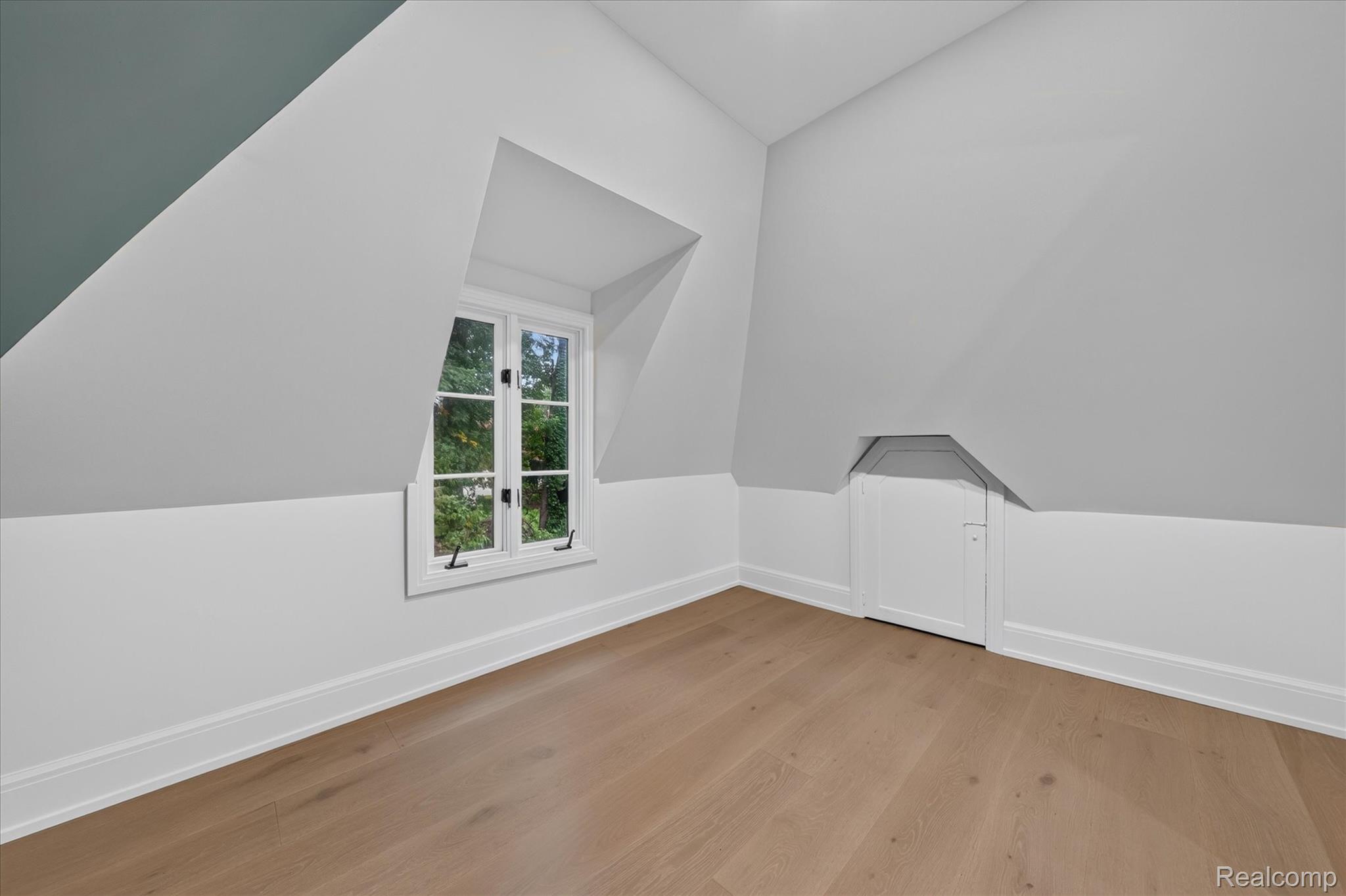 3250 Sherbourne Road Detroit, MI 48221 - Photo 22 of 36 Dormer window with casement openers, wood-finish flooring, and sloped ceilings