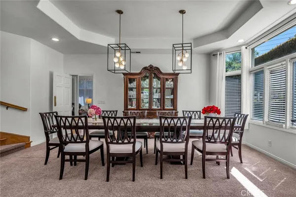 a view of a dining room with furniture and chandelier