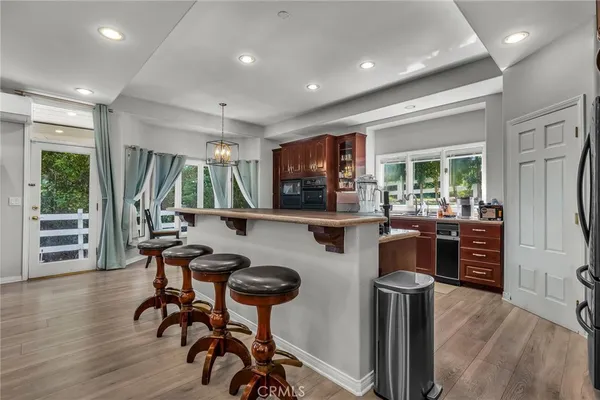 a livingroom with furniture a floor to ceiling window and wooden floor