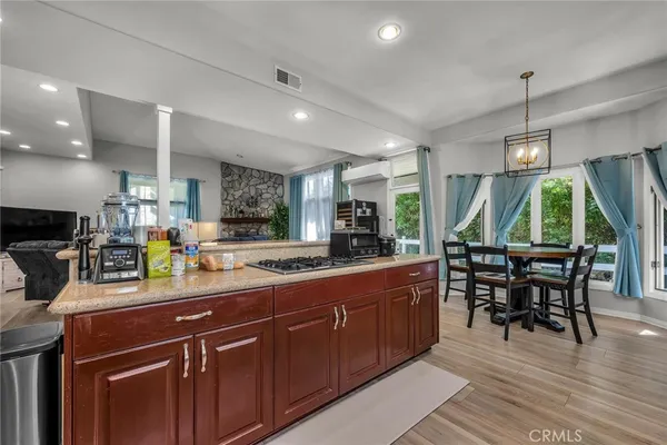 a kitchen with a sink a counter space appliances and dining table