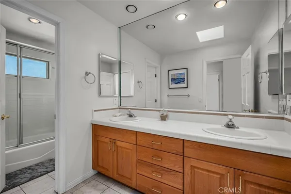 a bathroom with double sink and a mirror